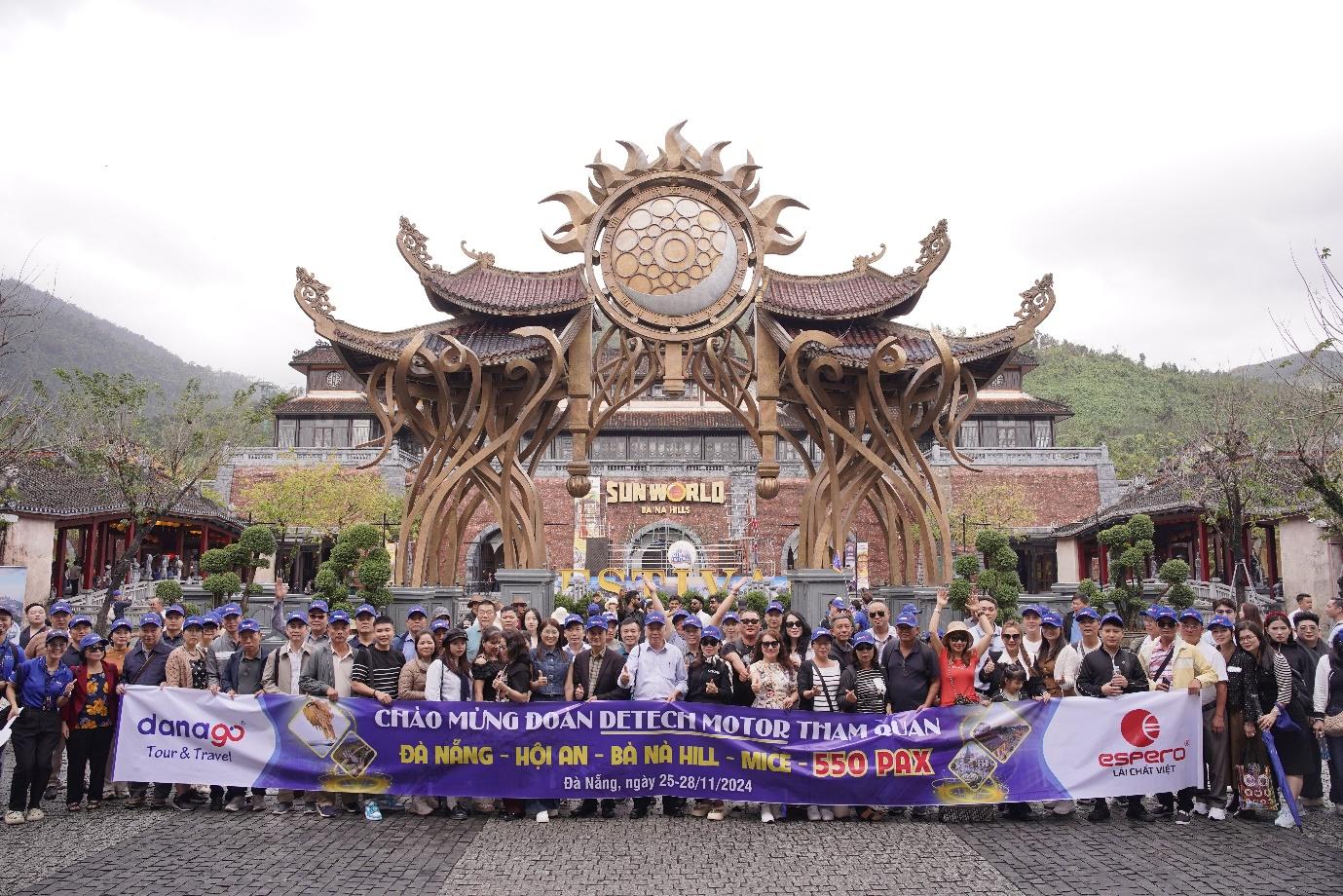 A group of people holding a banner in front of a building 
Description automatically generated